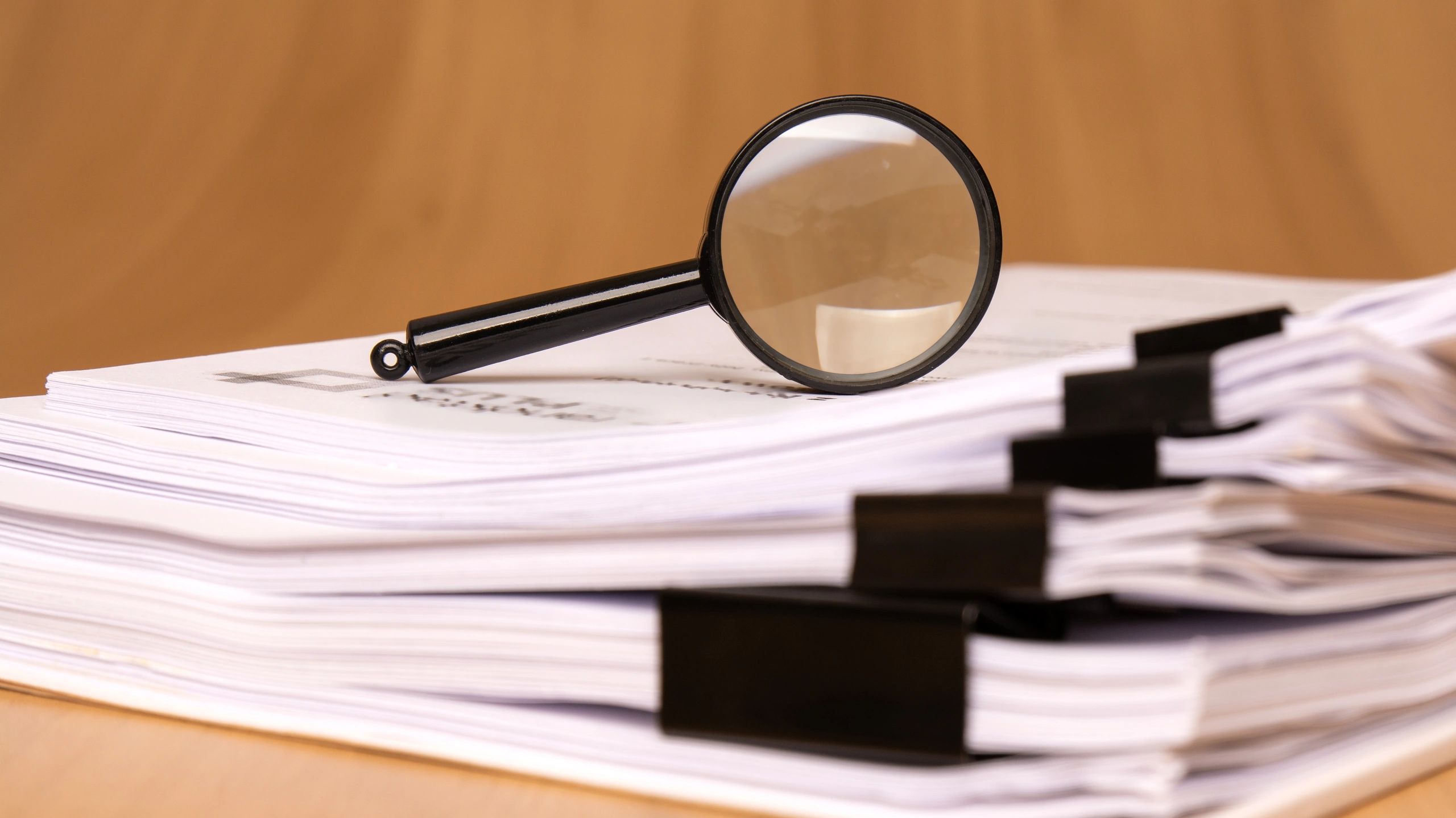 Magnifying glass on documents representing legal review