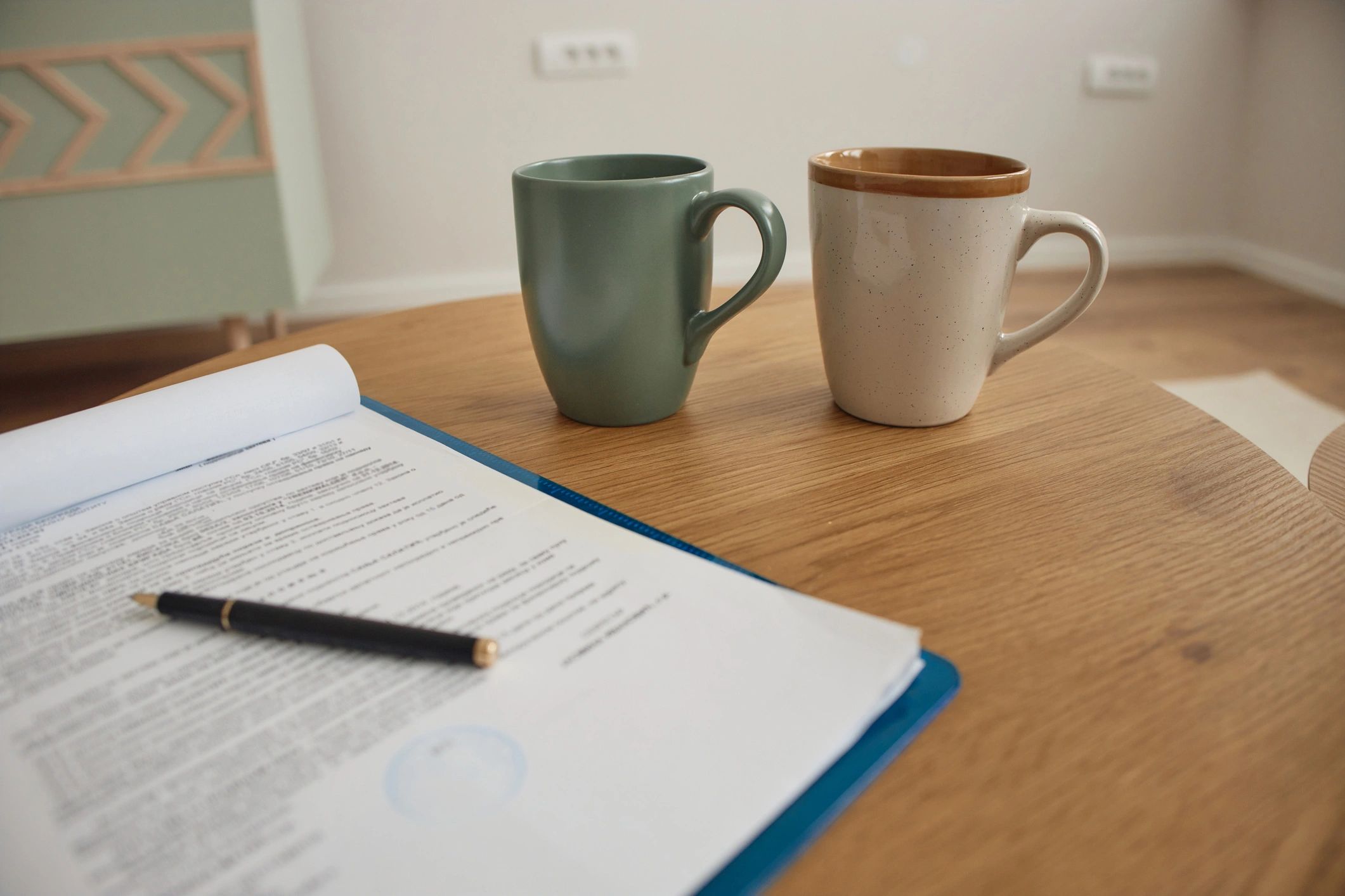 Contract documents and coffee on a meeting table